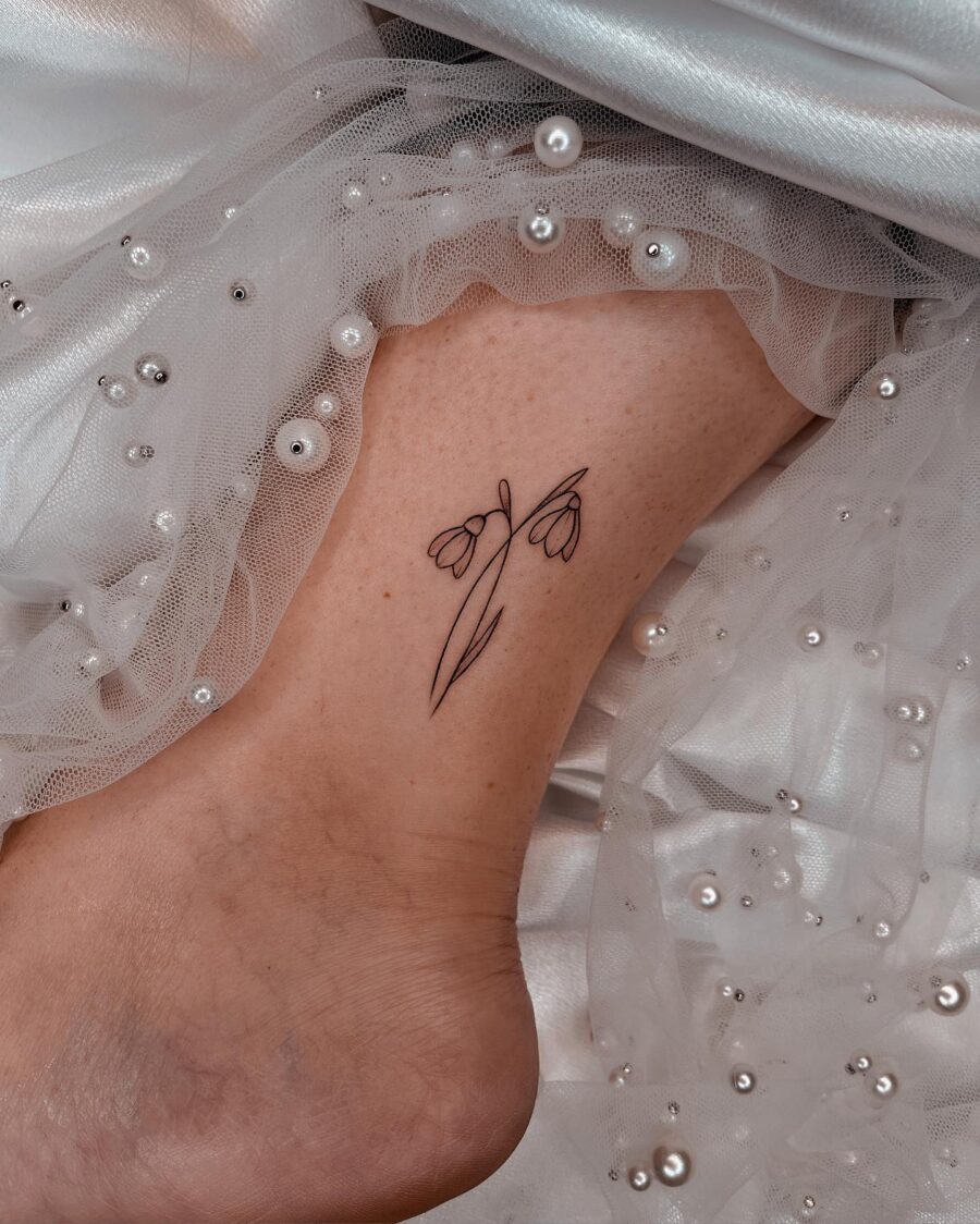 Elegant snowdrop tattoo on the ankle Tattoo on skin