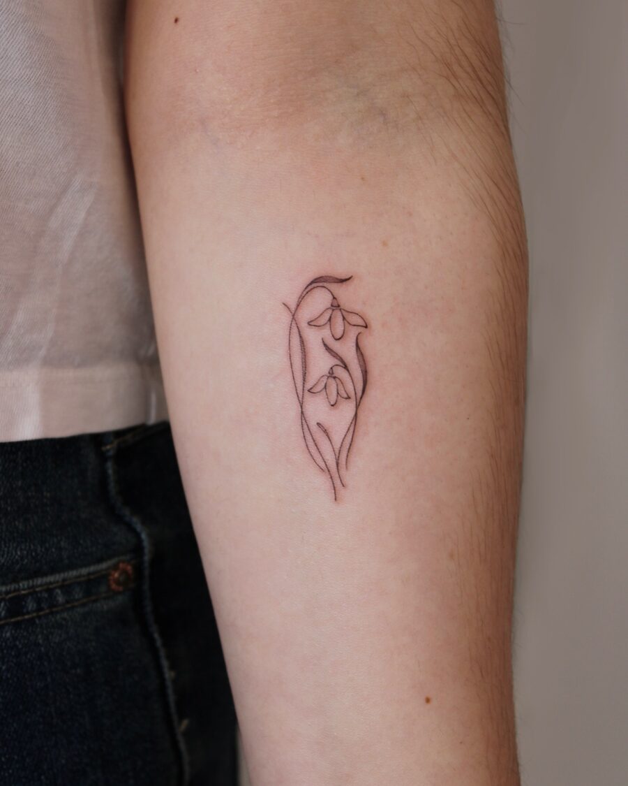 Elegant snowdrop tattoo showcasing delicate beauty Tattoo on skin
