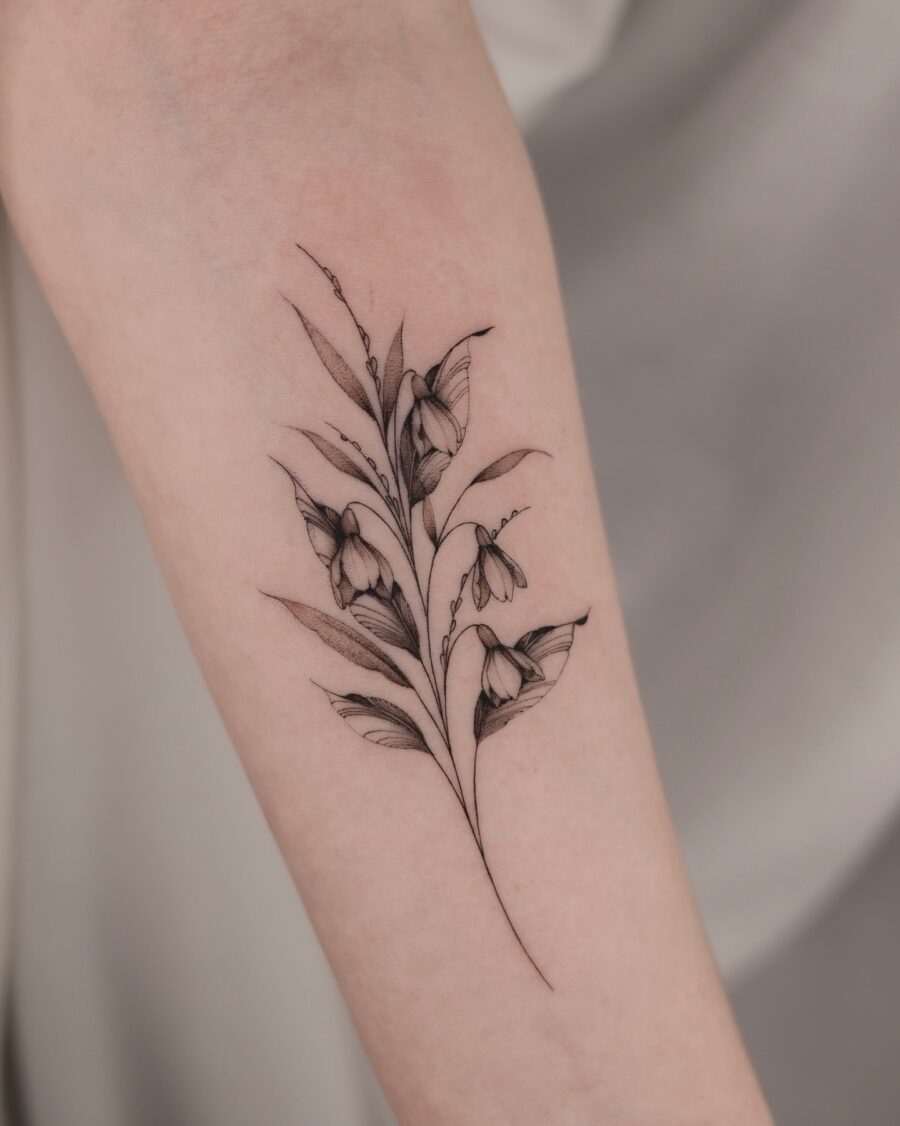 Elegant snowdrop tattoo showcasing delicate floral details Tattoo on skin