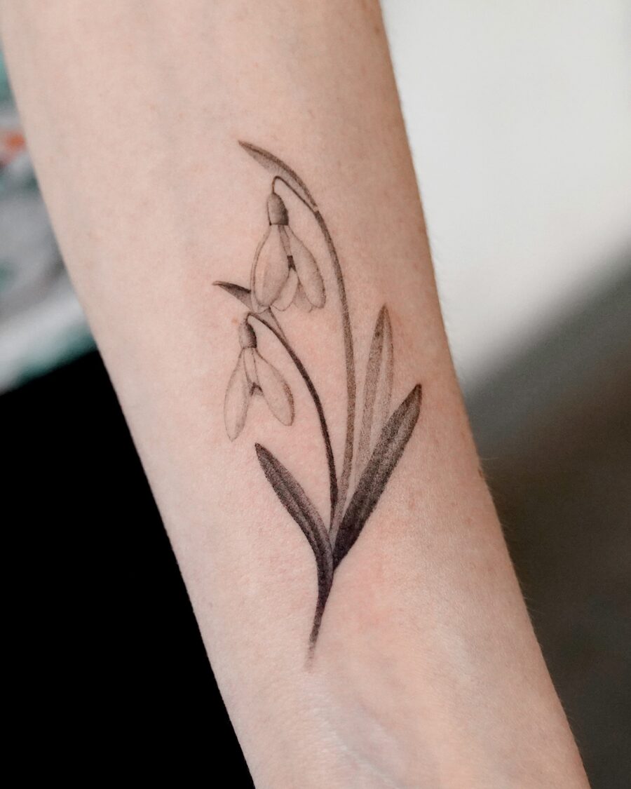 Elegant snowdrop tattoo with delicate details Tattoo on skin