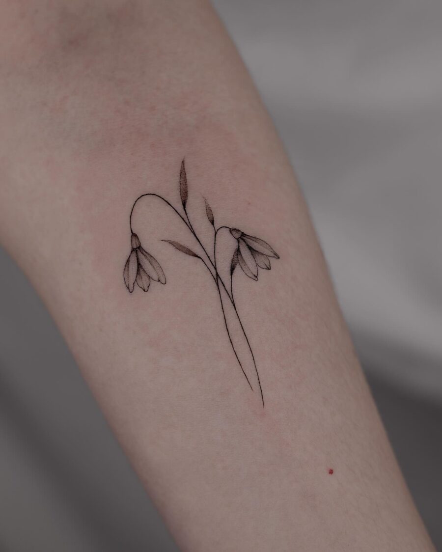 Elegant snowdrop tattoo with fine detailing Tattoo on skin