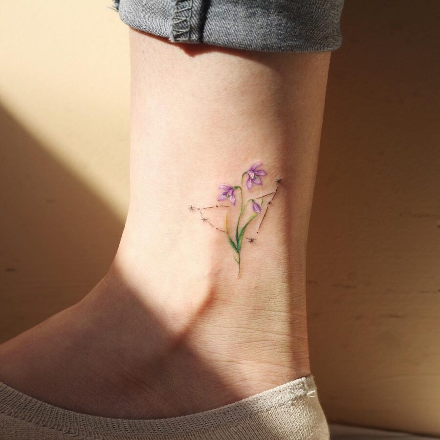 Elegant snowdrop tattoo with starry accents Tattoo on skin