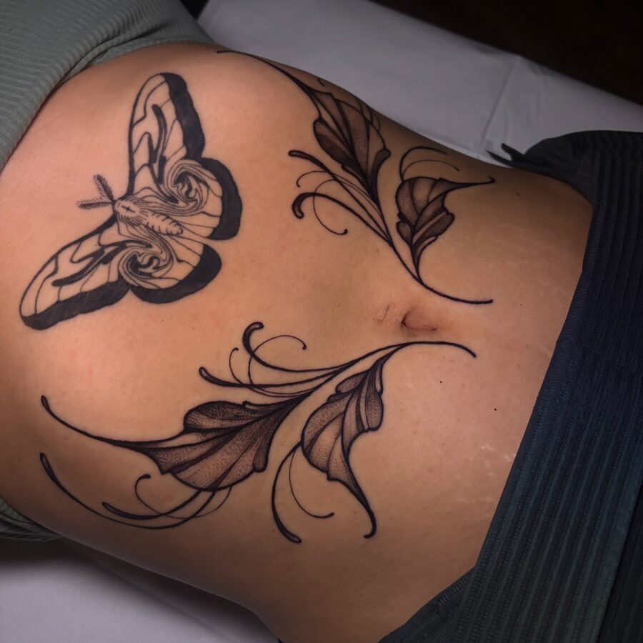 Delicate moth and leaves stomach tattoo design Tattoo on skin