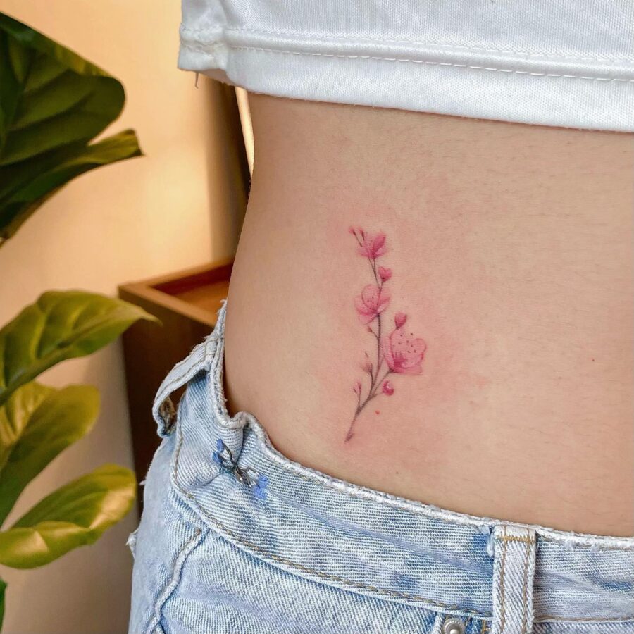 Delicate pink floral stomach tattoo design Tattoo on skin
