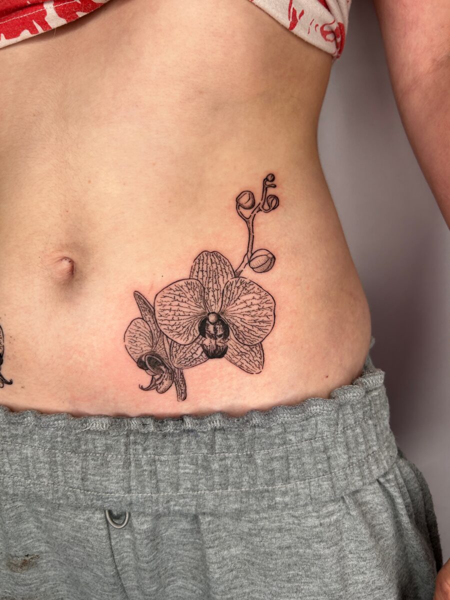 Elegant orchid tattoo on the stomach Tattoo on skin