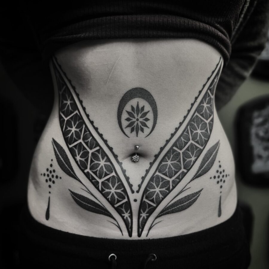 Intricate floral design on the stomach Tattoo on skin