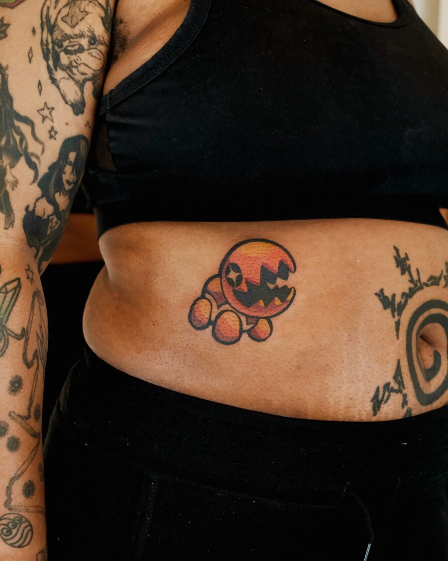 Playful cartoon-inspired stomach tattoo design Tattoo on skin