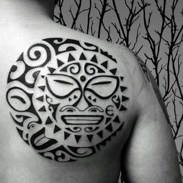 Gleeful Sun Smiles With a Tribal Angry Moon Tattoo on skin