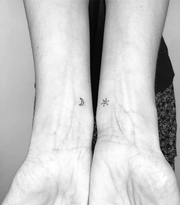 Simplistically Small Sun and Moon Wrist Ink Tattoo on skin