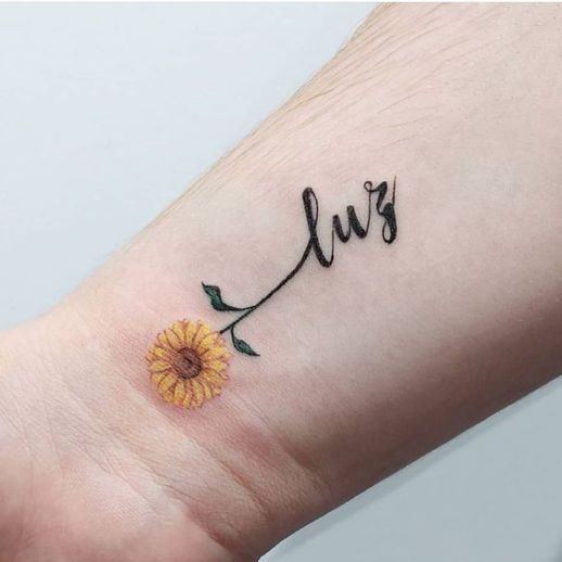 Charming Sunflower Tattoo with Bold Cursive Writing Tattoo on skin