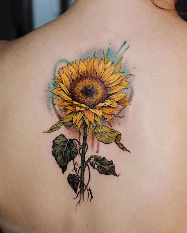 Ethereal Sunflower Tattoo Ideas with Soft Blue Background Tattoo on skin