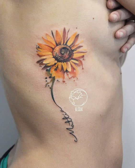Golden Sunflower Tattoo with Script Signature Tattoo on skin
