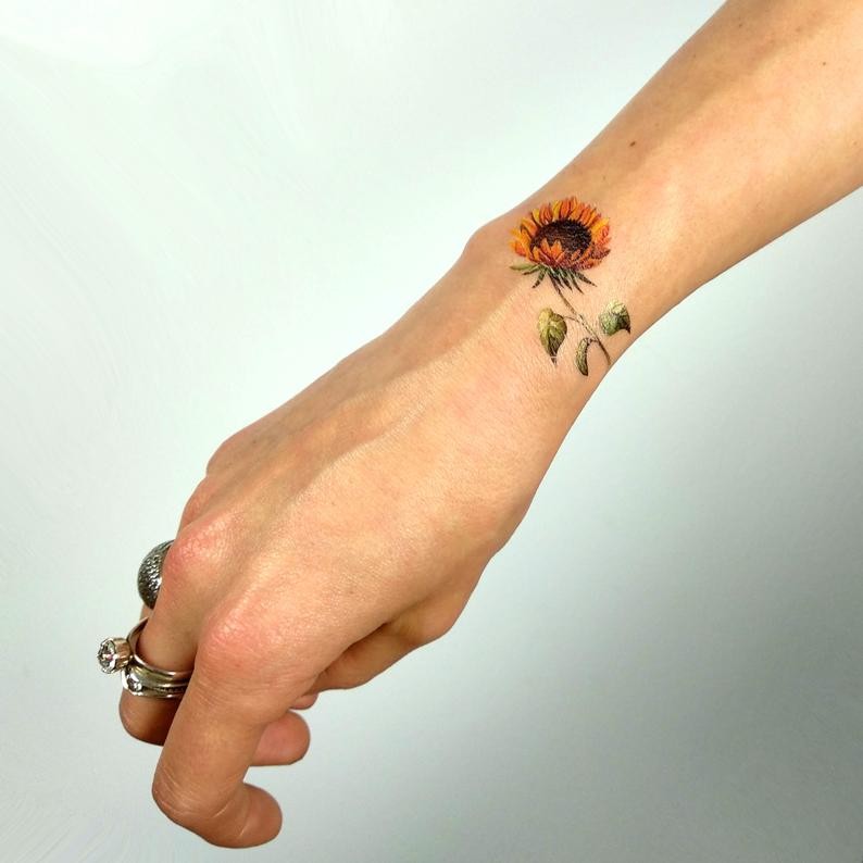 Realistically Colored Sunflower Wrist Tattoo Tattoo on skin