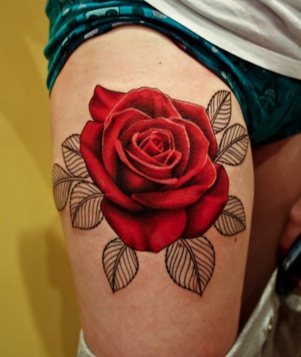 A beautiful red flower on the thigh Tattoo on skin
