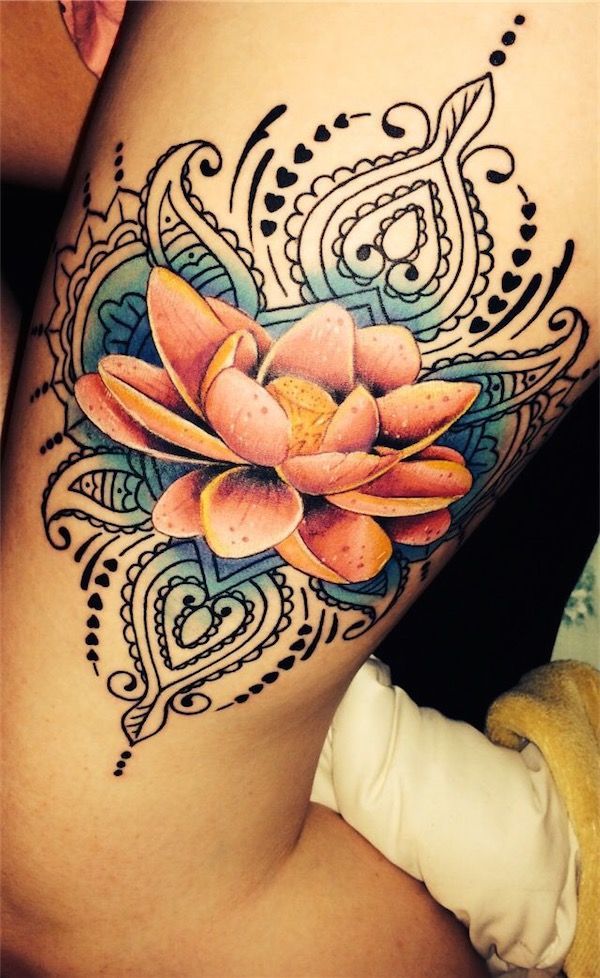 A beautifully decorated tattoo with a crown and a flower thigh tattoo Tattoo on skin