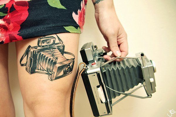 A camera tattoo on the thighs Tattoo on skin