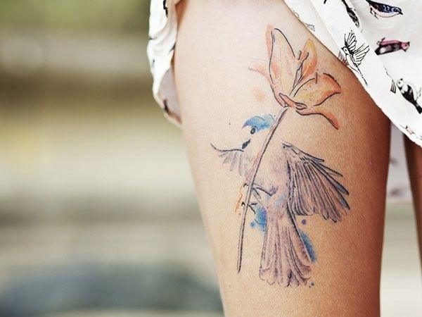 A simple bird and flower tattoo on the leg thigh tattoo Tattoo on skin