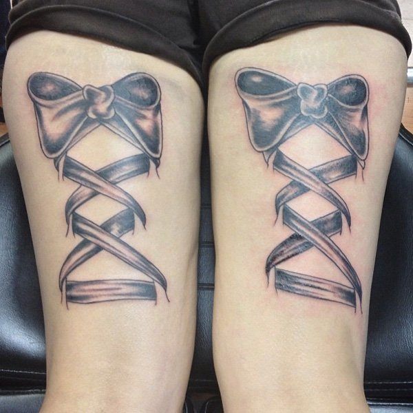 A unique ribbon ties tattoo Tattoo on skin