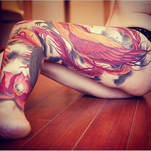 Brightly decorated flower tattoo on the thighs Tattoo on skin