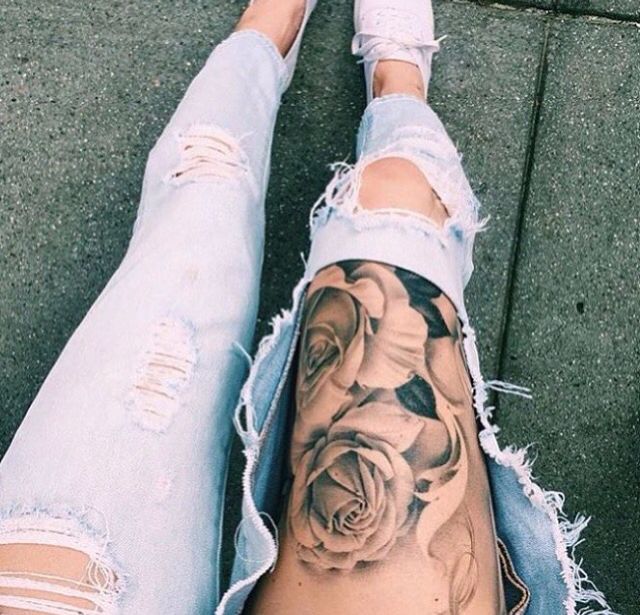 Flower tattoo matching well with the dirt jeans thigh tattoo Tattoo on skin