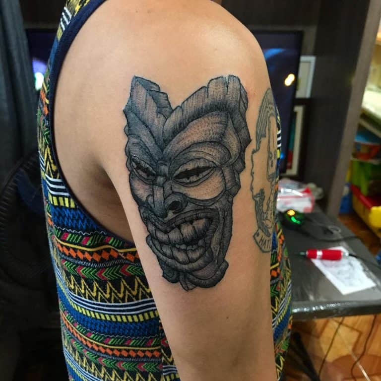 Depiction of Carved Tiki Mask Tiki Tattoo Tattoo on skin