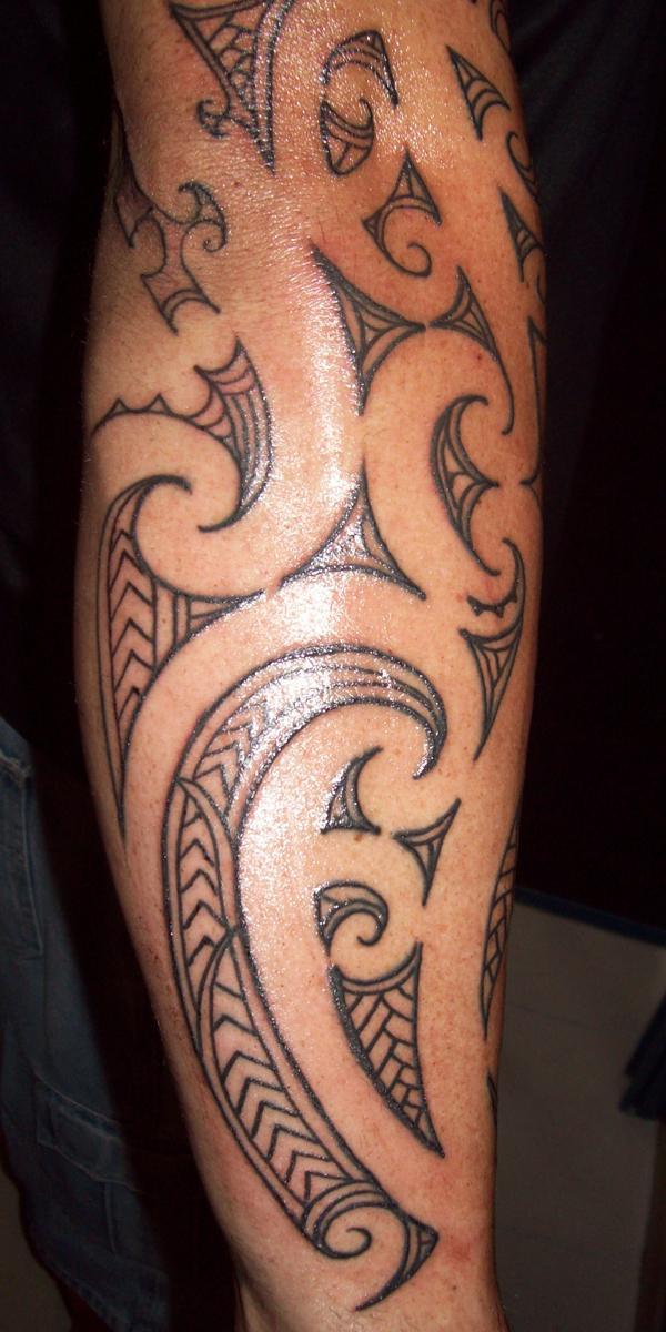 A curved pattern Tribal arm Tattoo Tattoo on skin