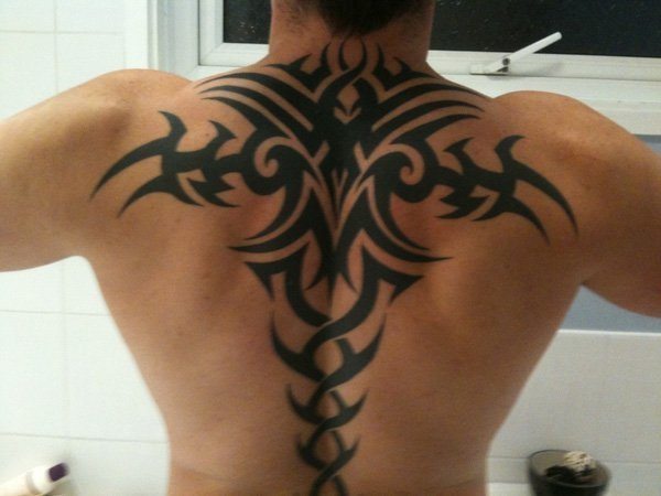 A modern Tribal Tattoo on the back of a man Tattoo on skin