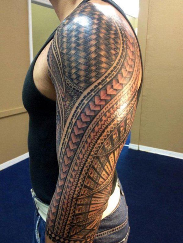 A multi Coloured and very beautiful Tribal Tattoo on a man's arm Tattoo on skin