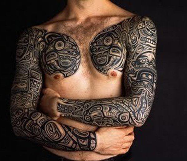 Two arms covering Tribal Tattoo Tattoo on skin
