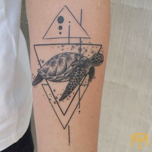 Sea Turtle Framed by Triangles Tattoo on skin