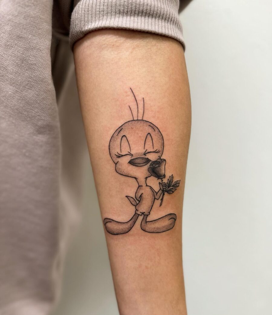 Adorable Tweety Bird Tattoo with a Rose Tattoo on skin