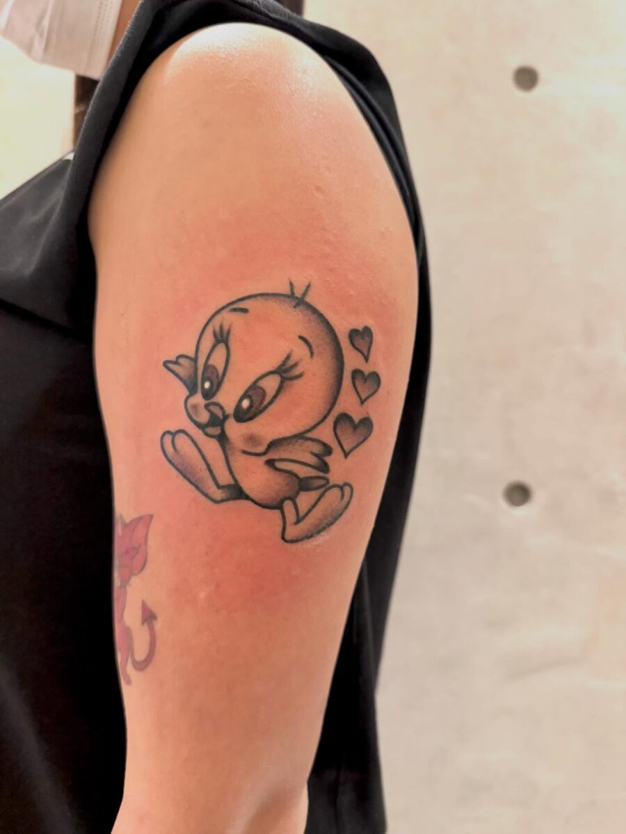 Adorable Tweety Bird with Hearts Tattoo Tattoo on skin