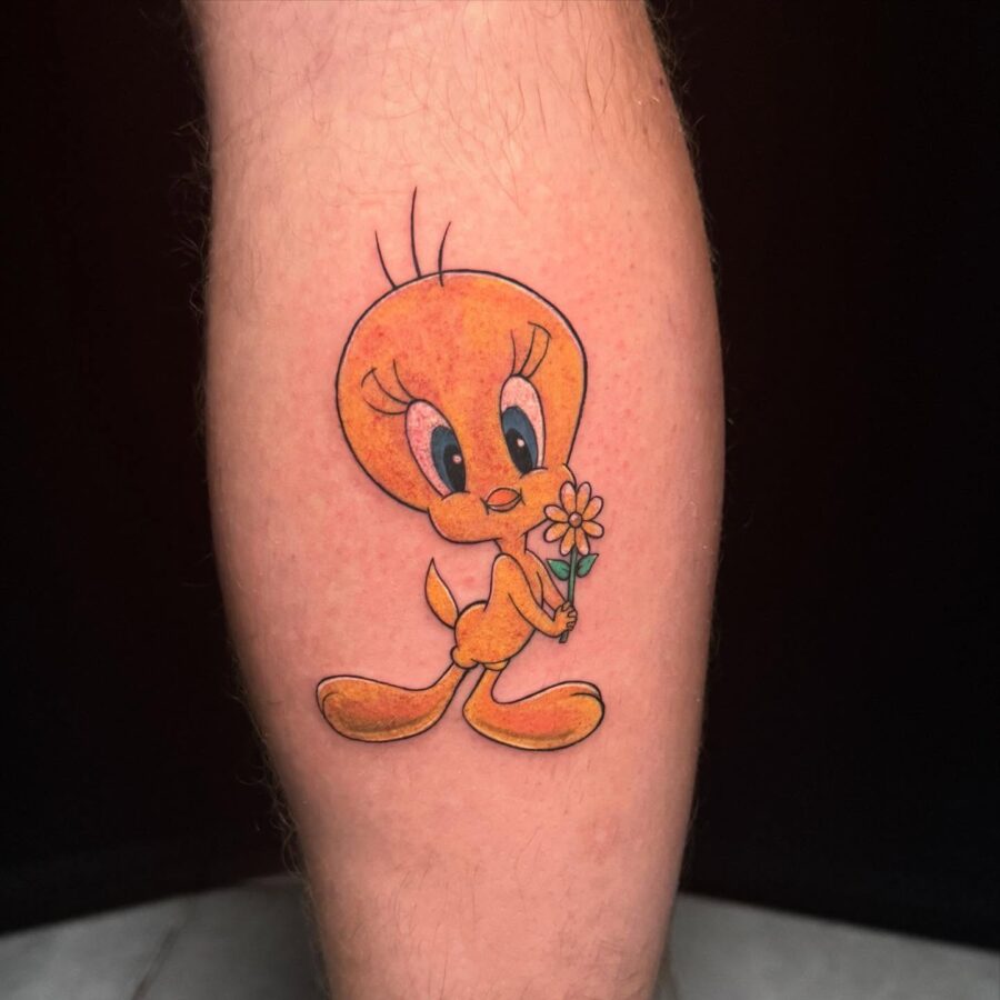 Charming Tweety Tattoo Holding a Flower Tattoo on skin