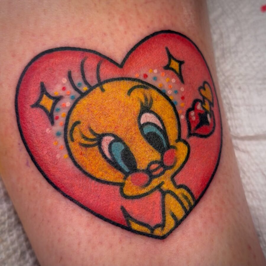 Cheerful Tweety Bird in a Heart Design Tattoo on skin