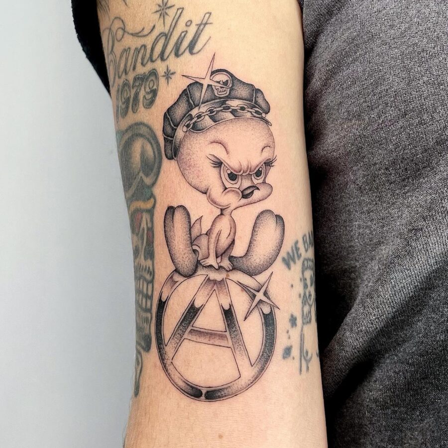 Edgy Tweety Teeters on Anarchy Symbol Tattoo on skin