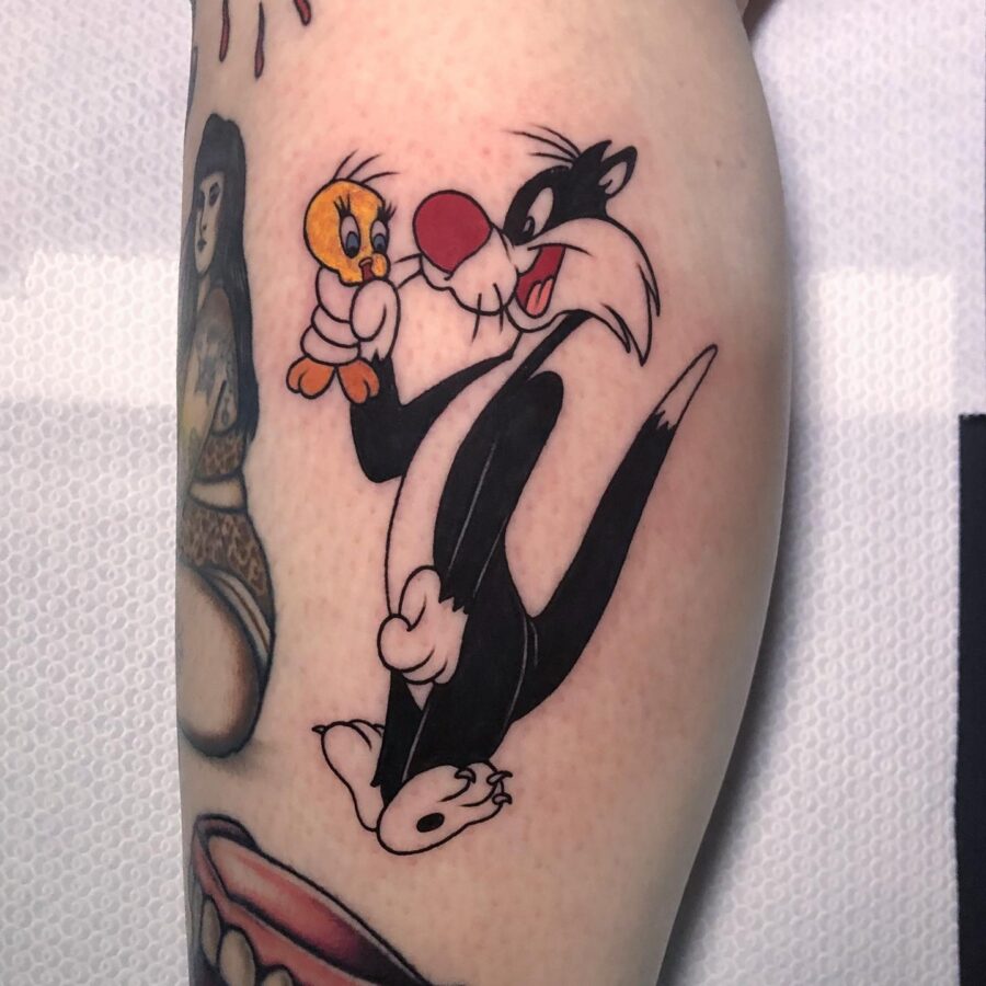 Playful Sylvester and Tweety Tattoo Design Tattoo on skin