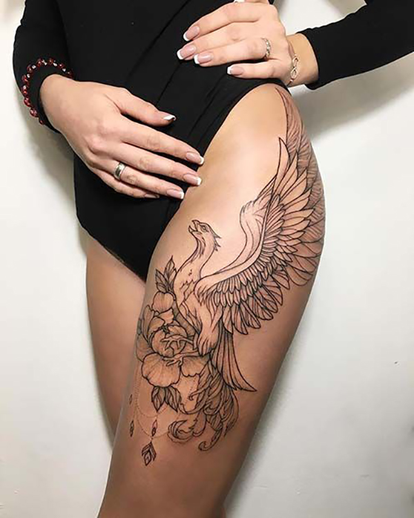The Rising Phoenix and Floral Thigh Tattoo on skin