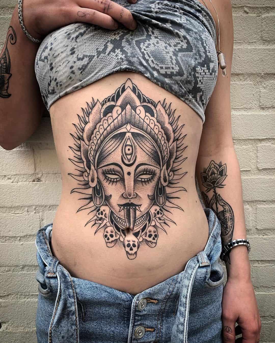 The Sacred Goddess Kali Stomach and Navel Tattoo on skin