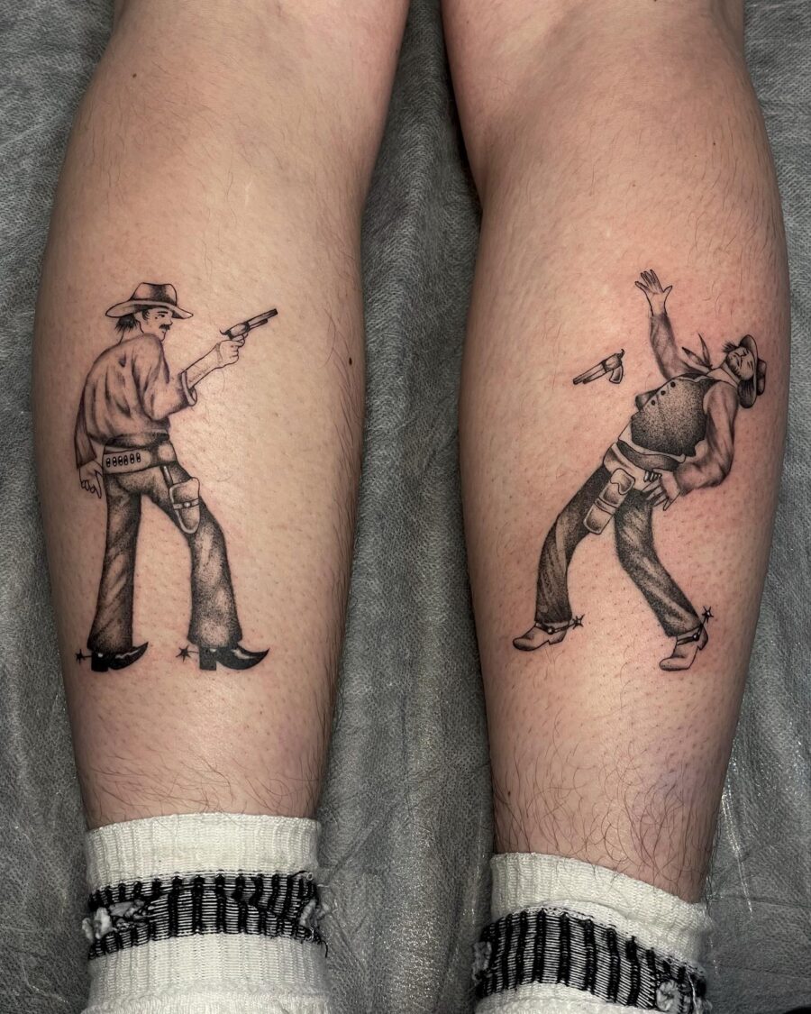 Dynamic cowboy duel tattoo with vintage flair Tattoo on skin