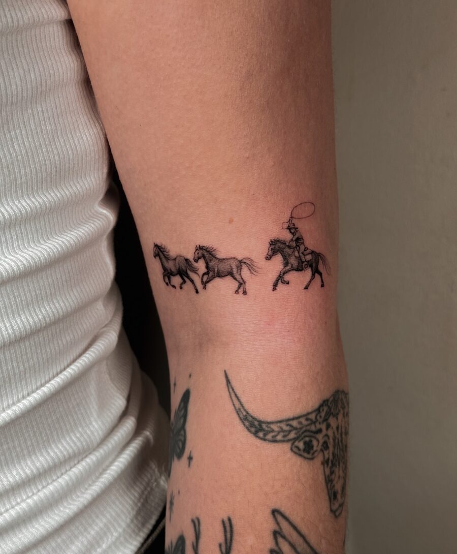 Dynamic depiction of horses and rider tattoo Tattoo on skin
