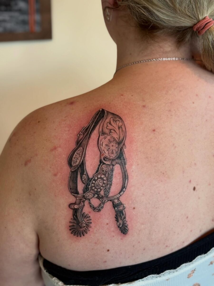Elegant spurs tattoo showcasing western heritage Tattoo on skin