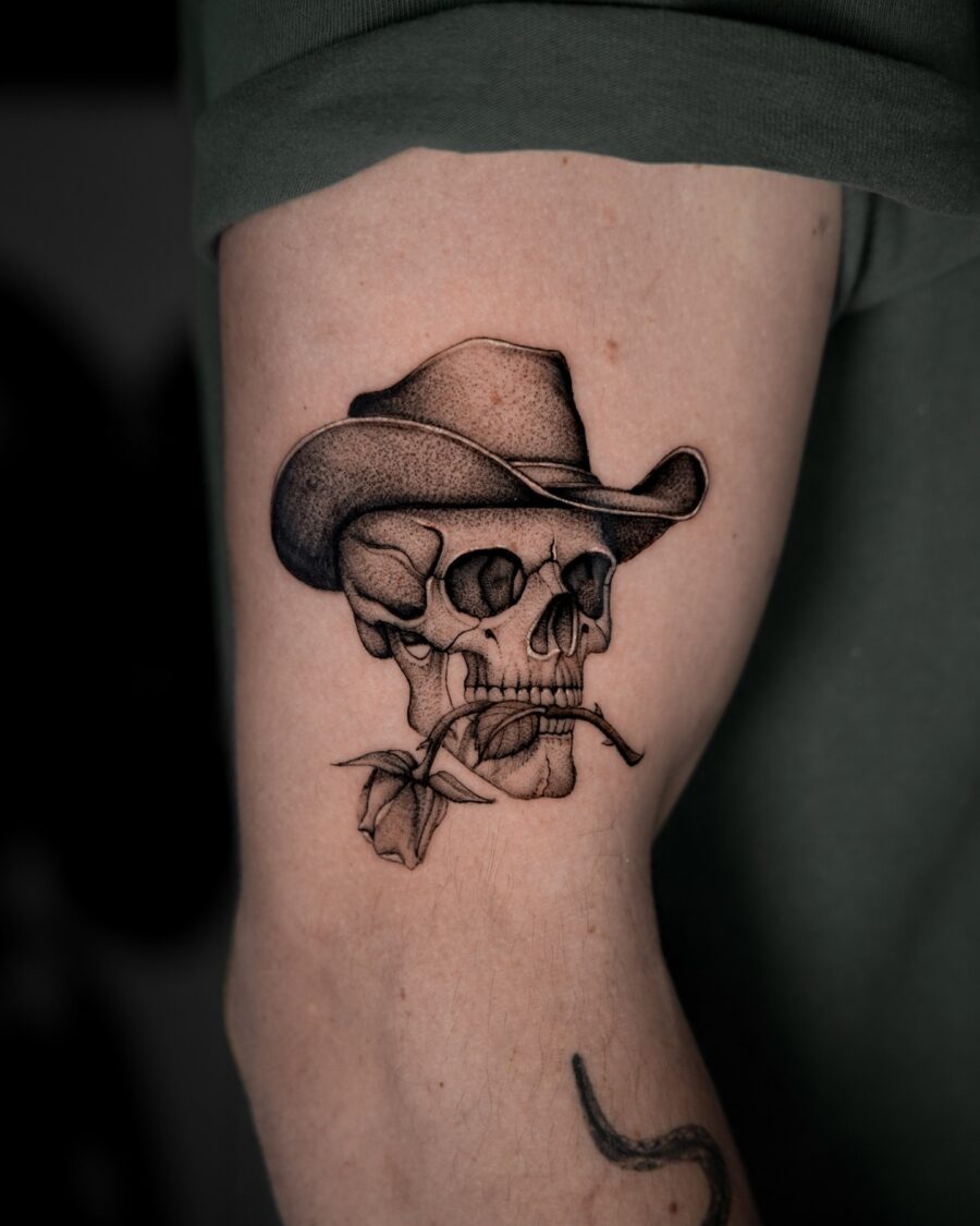 Intricate cowboy skull tattoo with floral elements Tattoo on skin