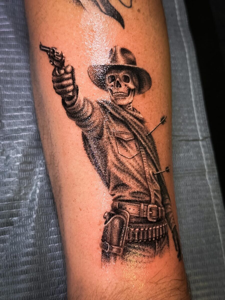 Striking skeleton cowboy in action pose Tattoo on skin