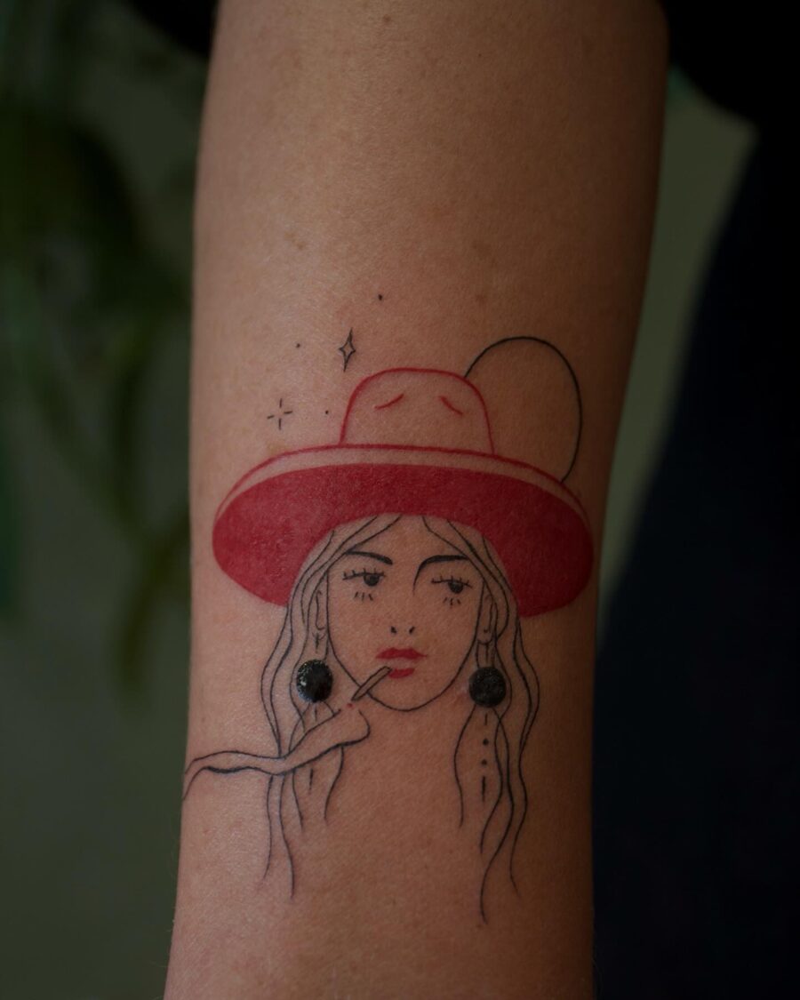 Stylish woman with wide-brimmed hat tattoo Tattoo on skin