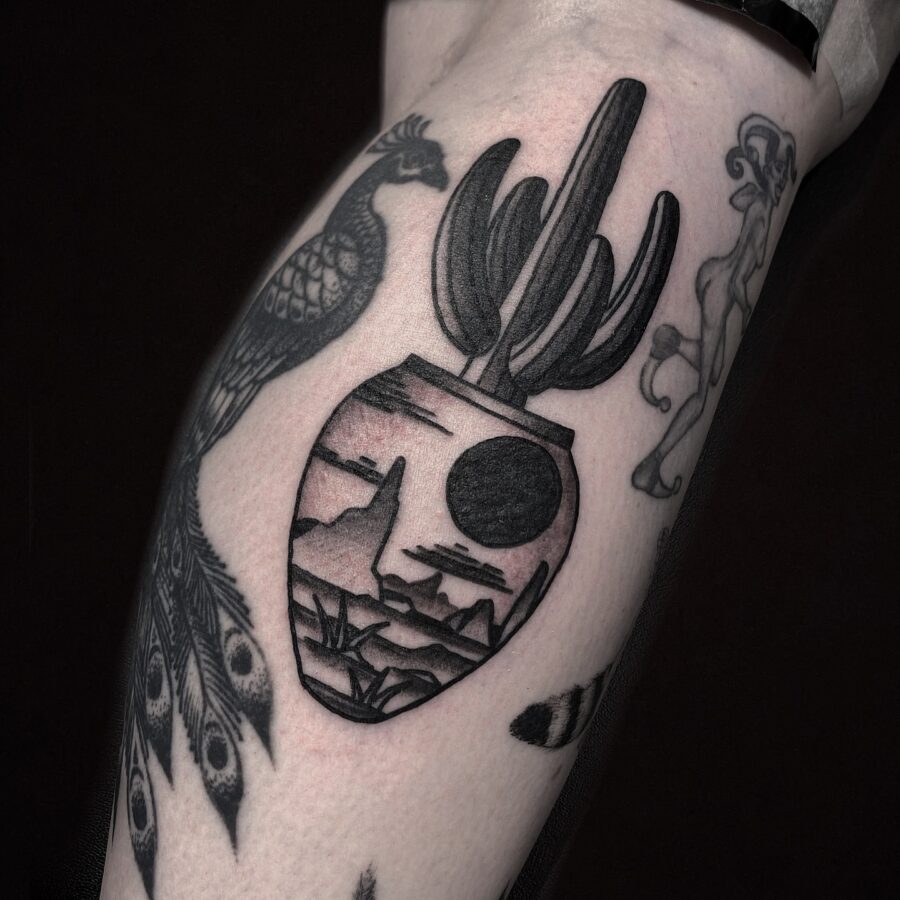 Unique cactus and mountain scene tattoo design Tattoo on skin