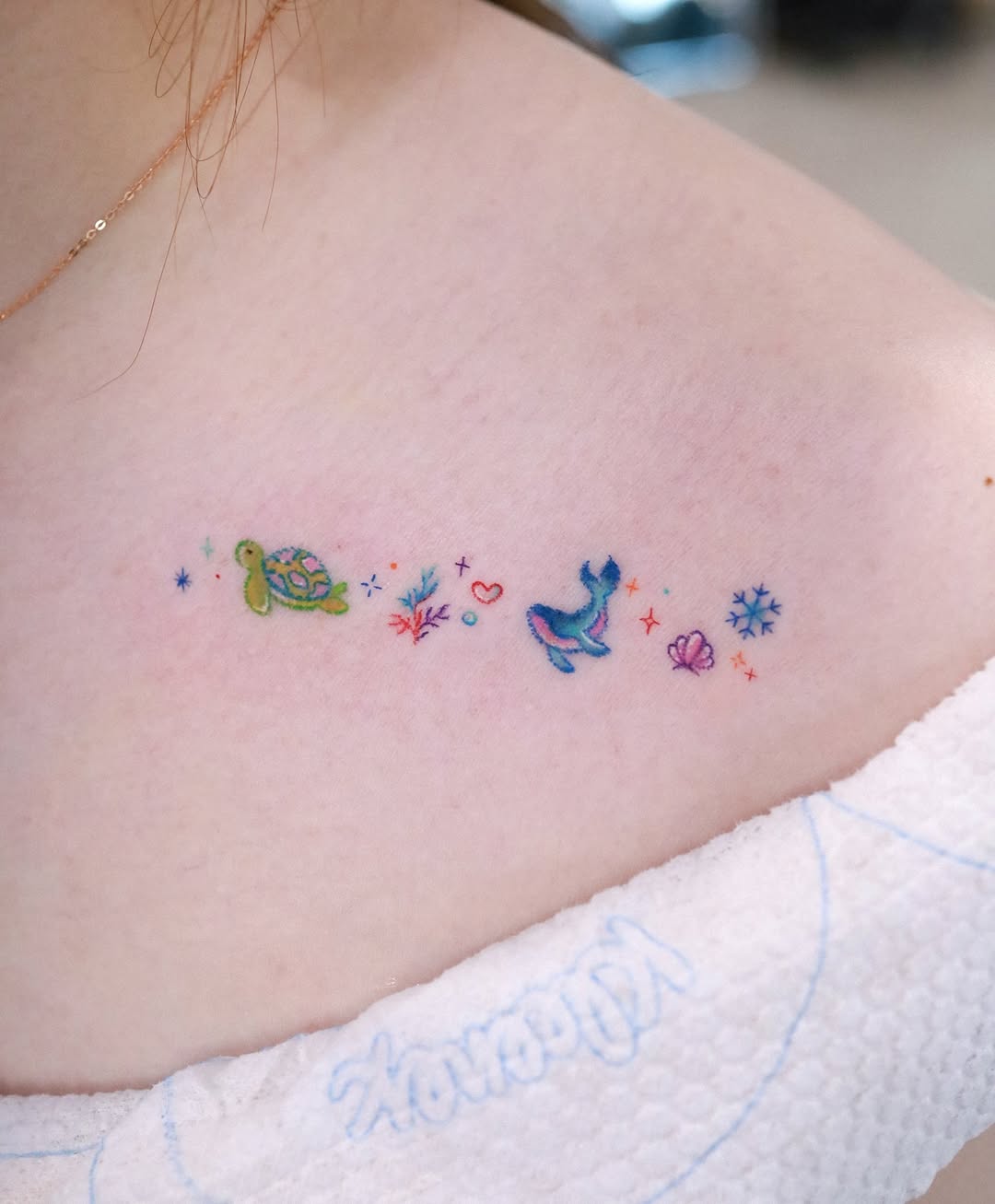 Charming minimalist whale tattoo with vibrant colors Tattoo on skin