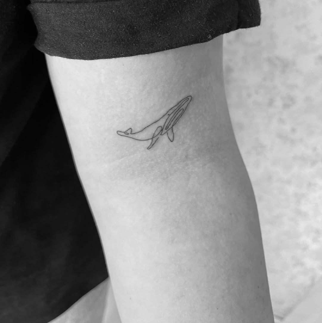 Chic Minimalist Whale Tattoo on Arm Tattoo on skin