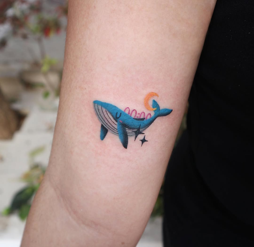 Colorful minimalist whale tattoo on the arm Tattoo on skin