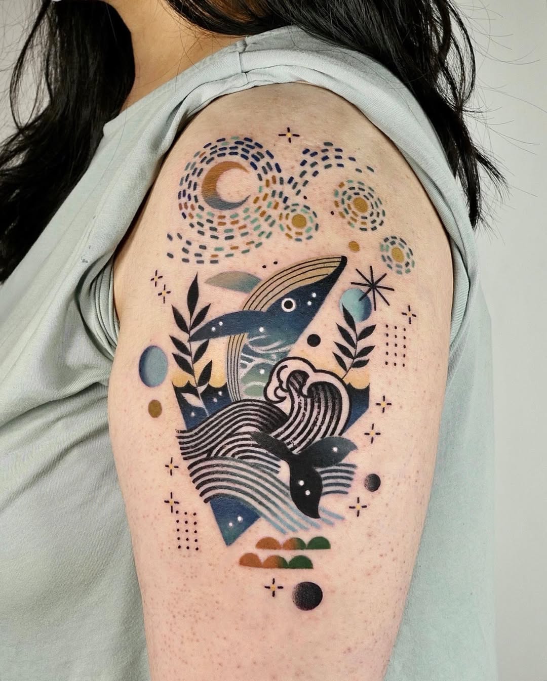 Colorful whale tattoo with cosmic elements Tattoo on skin