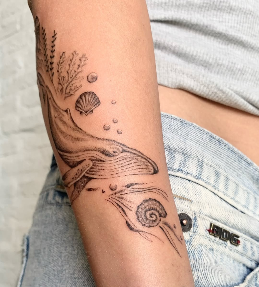 Elegant minimalist whale tattoo on the arm Tattoo on skin